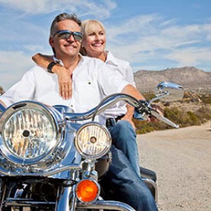 Retirees on a motorcycle enjoying the countryside