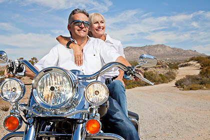 Retirees on a motorcycle enjoying the countryside